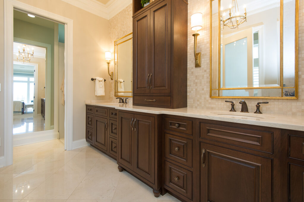 Master bathroom remodel in Algonquin IL with dark wood double vanity, quartz countertops, and gold framed mirrors