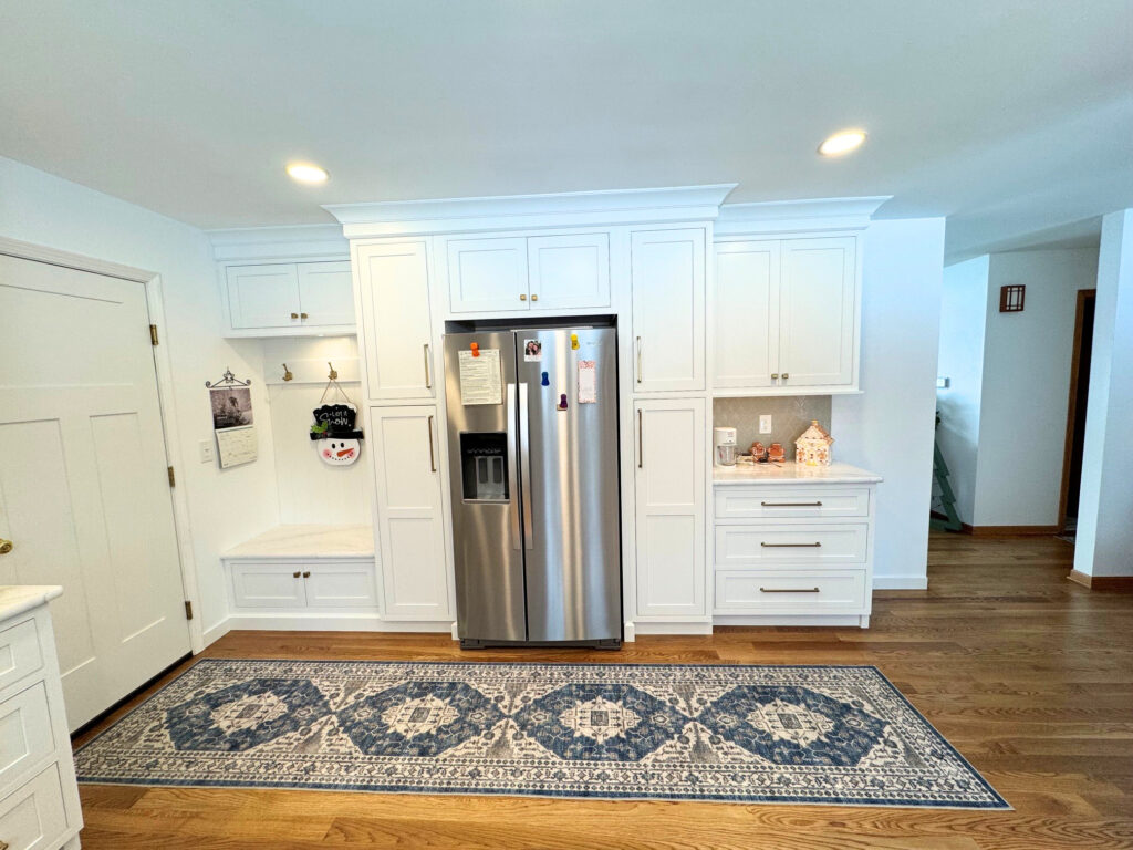 Custom white kitchen remodel in Harvard IL with inset cabinetry and mudroom bench