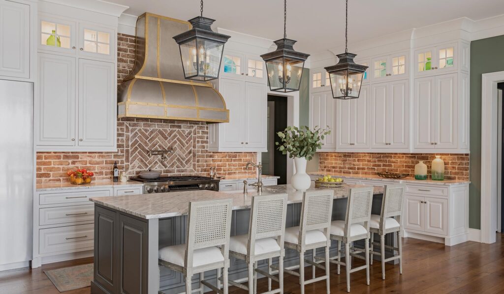 Luxury white kitchen remodel with brick backsplash and custom hood