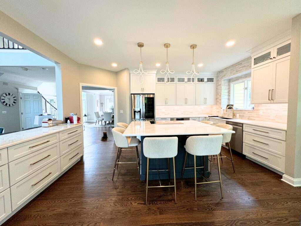 Completed kitchen remodel in Lake in the Hills featuring white cabinets, quartz countertops, and hardwood flooring
