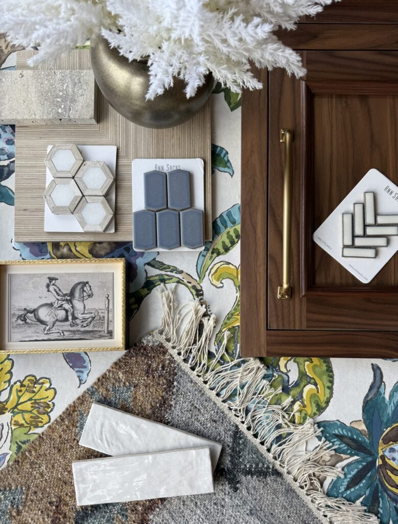 Natural walnut cabinetry with brass hardware, tile samples, and kitchen design inspiration materials.