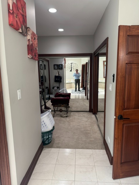 Original primary closet area before a master bathroom remodel in Woodstock, IL prior to separating the closet from the bathroom with a new interior door.