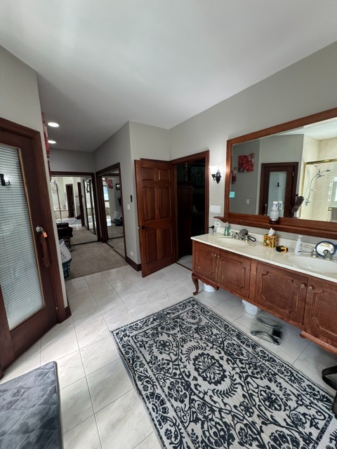 Original master bathroom vanity before renovation in Woodstock, IL showing outdated cabinetry and finishes prior to remodeling.