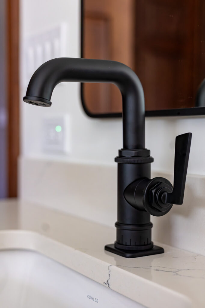 California Faucets Steampunk Bay bathroom faucet in a matte black finish installed on a Cambria Colton quartz vanity in a luxury master bathroom remodel in Woodstock, Illinois.