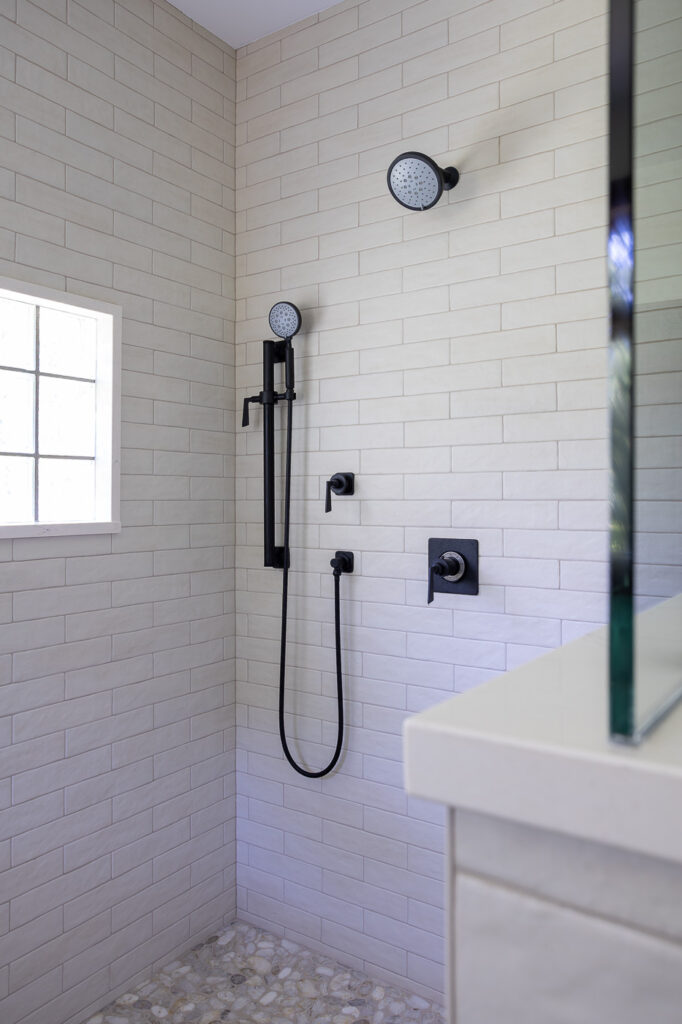 California Faucets Steampunk Bay shower system featuring a rain showerhead, handheld shower, and thermostatic valve in a luxury walk-in shower remodel in Woodstock, Illinois.