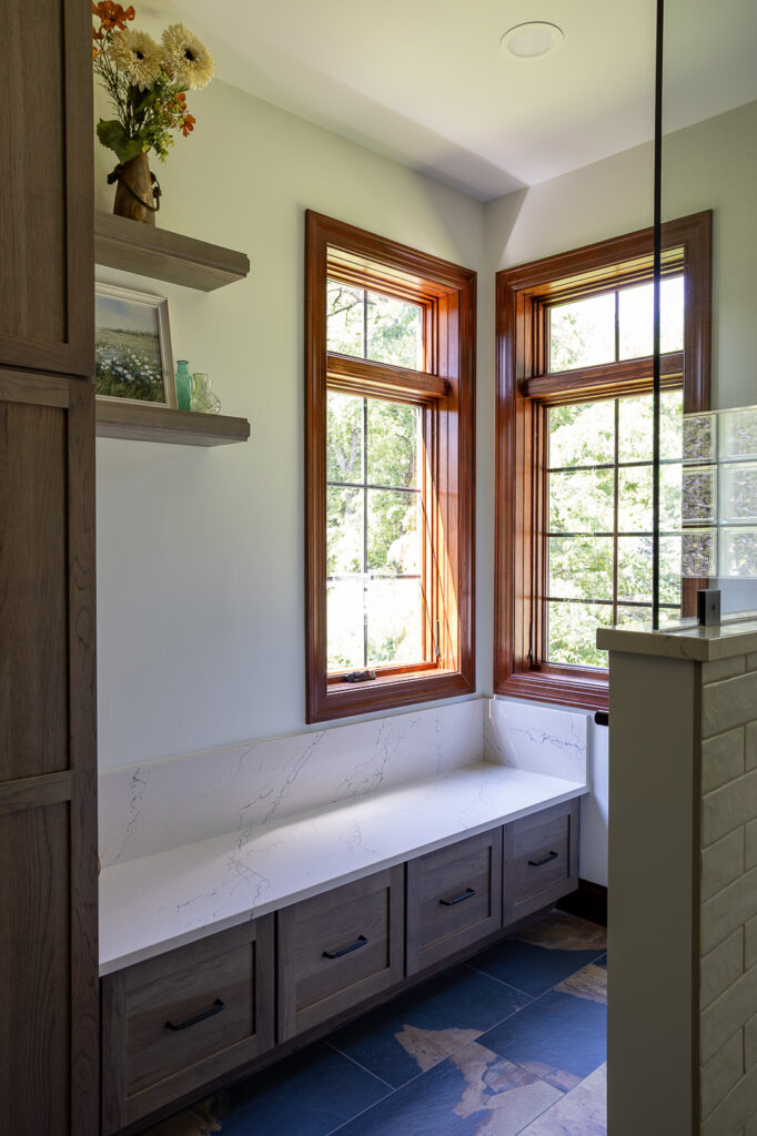 Marvin Elevate wood interior windows above a custom built-in window bench with storage in a luxury master bathroom remodel in Woodstock, Illinois by CSL Interior.